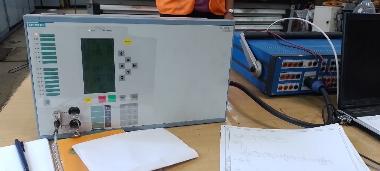 Rafi Nasrallah working on Siemens SIPROTEC relay testing.